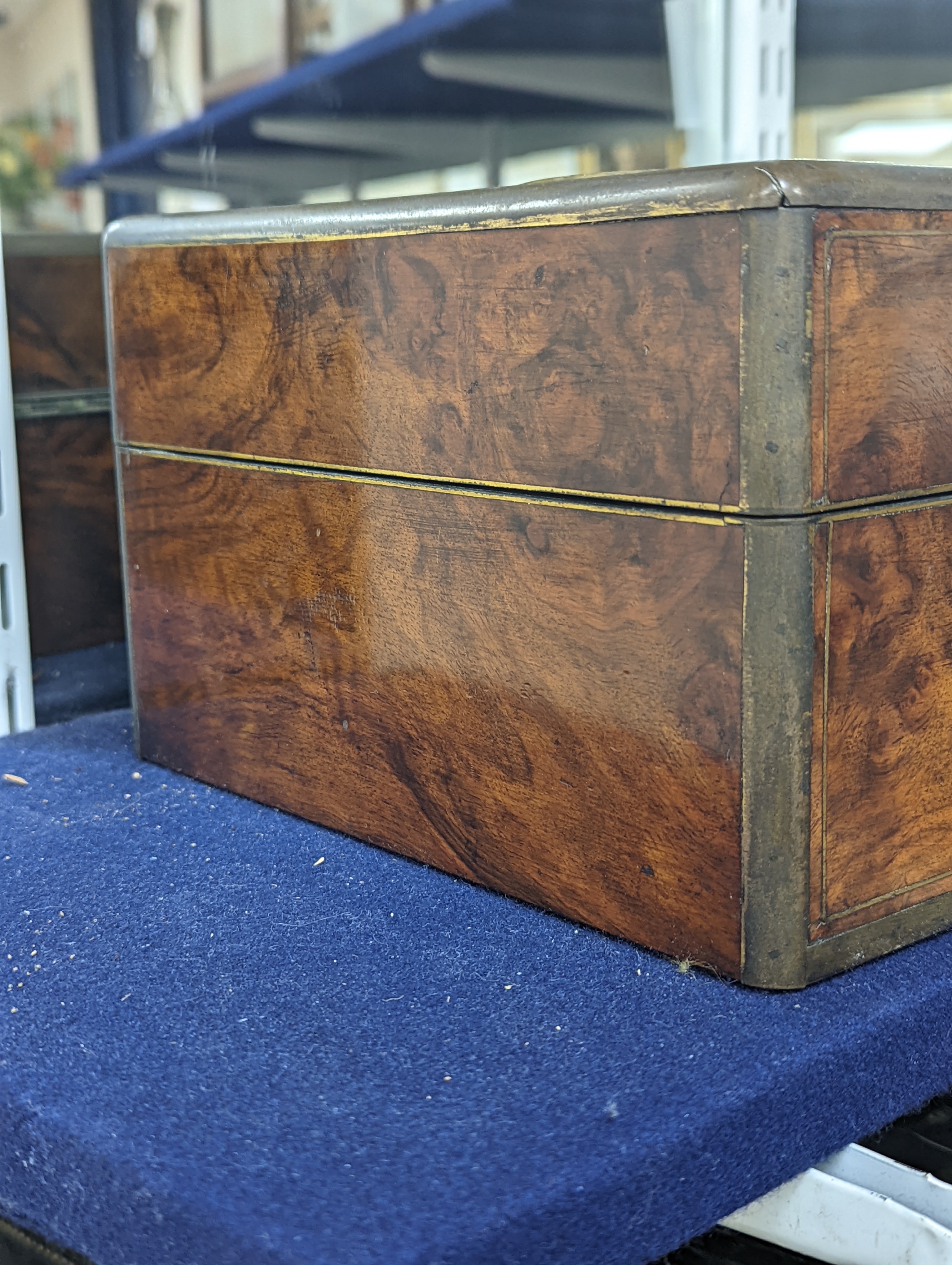 A Victorian brass mounted burr walnut toilet box, fitted with glass jars with electroplated tops, Width 30 cms. Ivory mounted items included